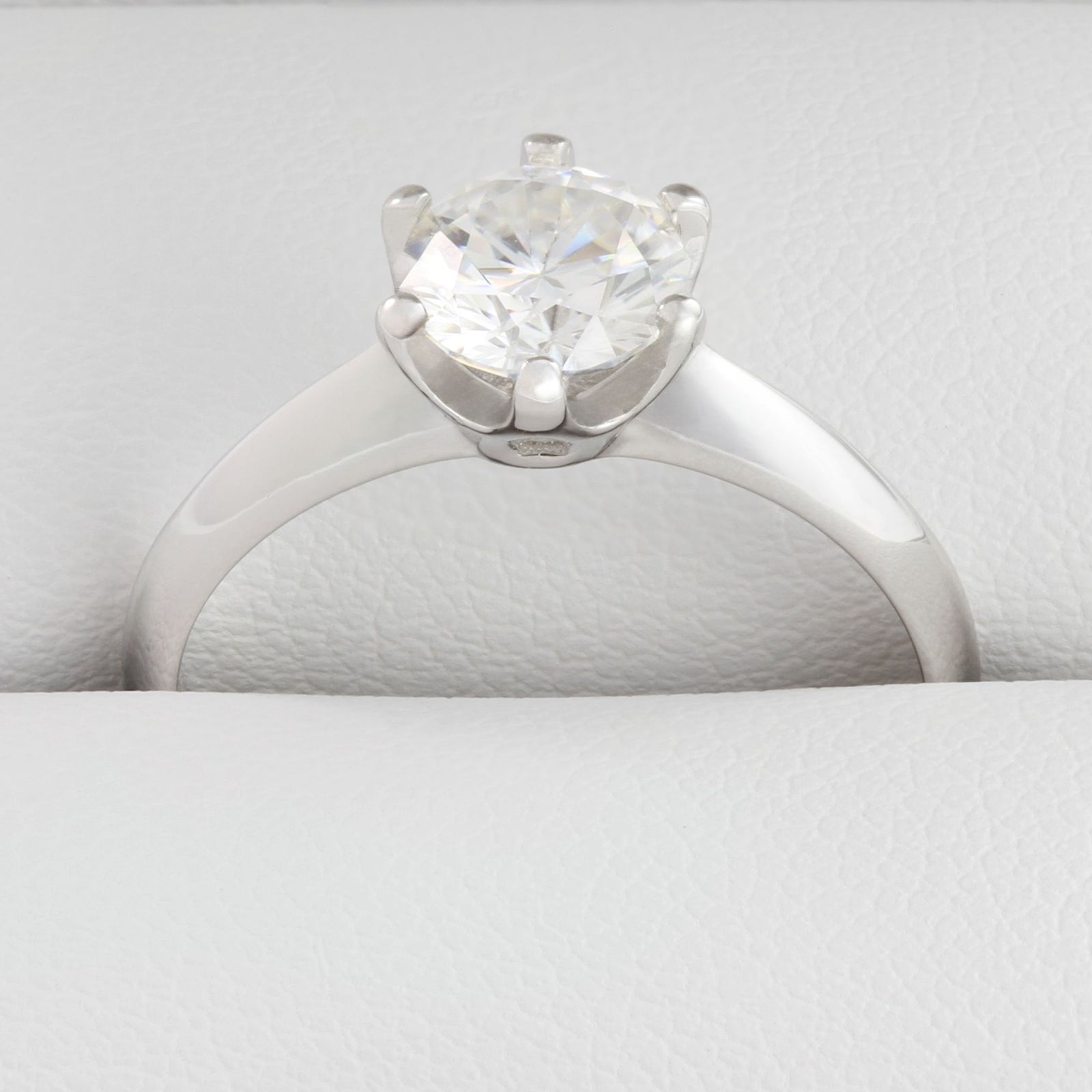 close up of white gold 1ct round moissanite solitaire ring with inset stone