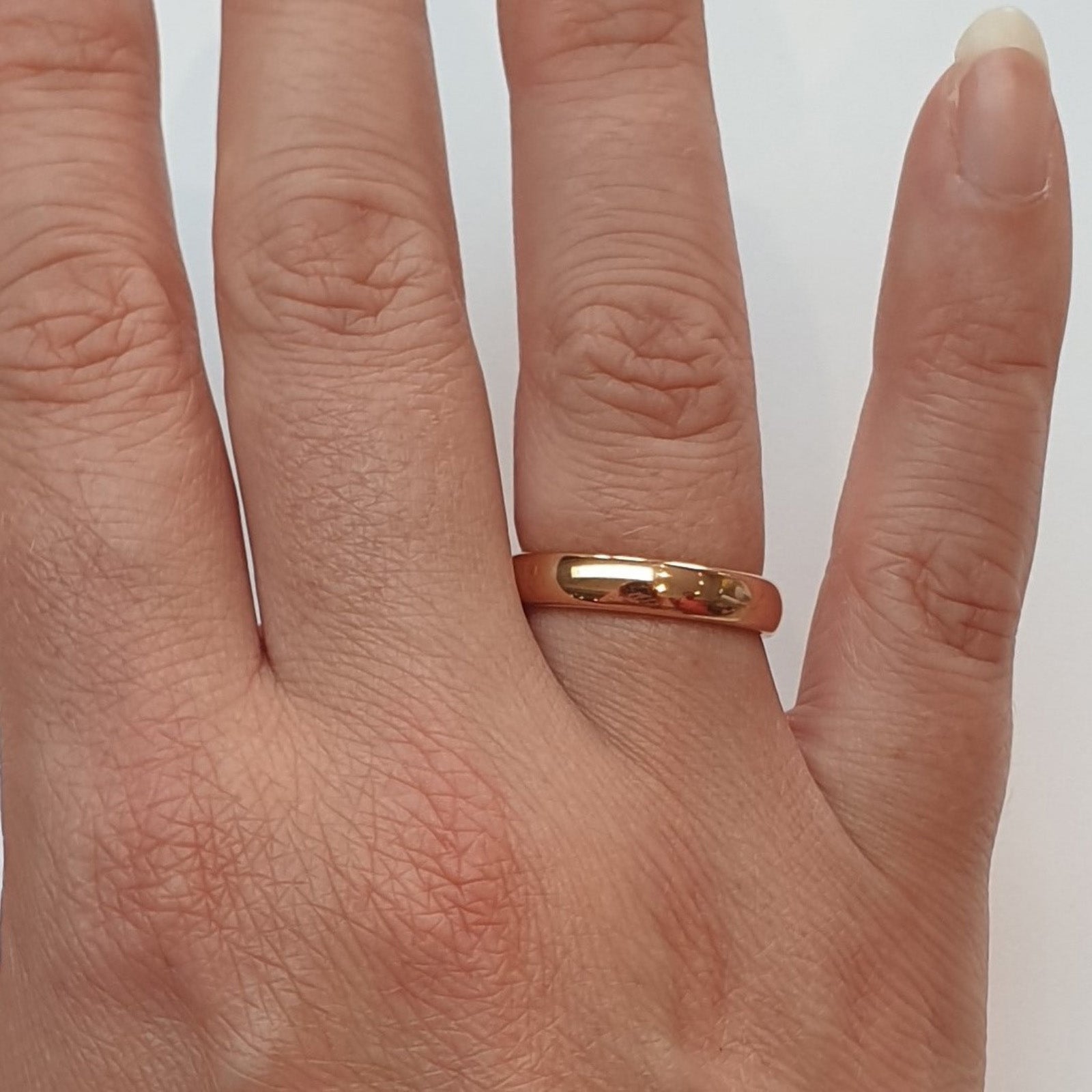 Close shot of rose gold tungsten ring on women's ring finger