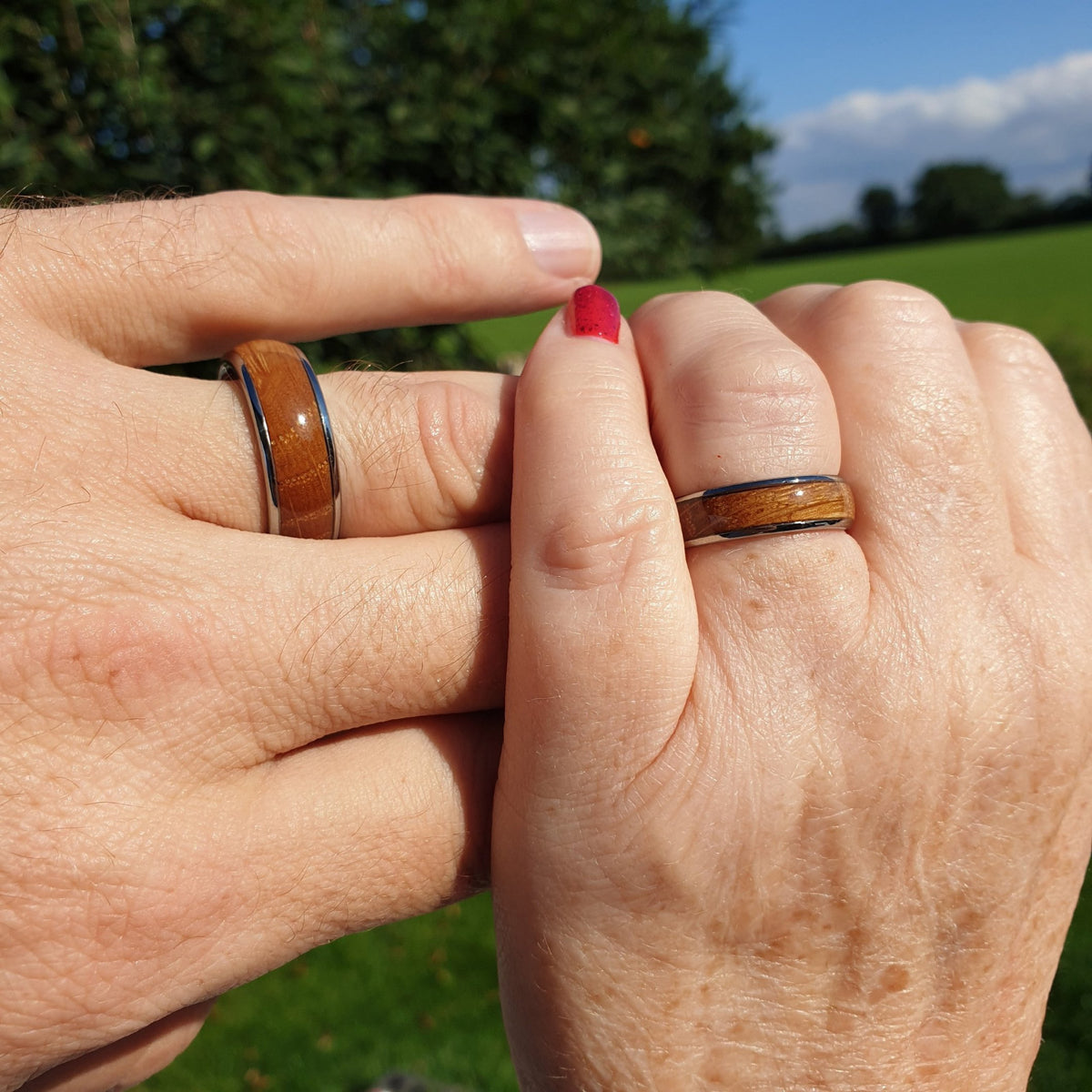 Pair of Wood inlay barrel rings on man and women's fingers