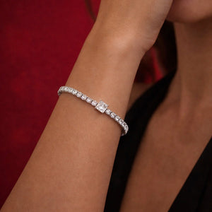 A close up of a women wearing the 1ct White Gold Moissanite Princess Tennis Silver Bracelet