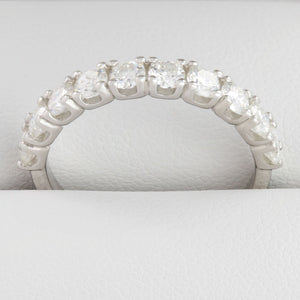 Close-up of round moissanite stones in white gold half eternity ring