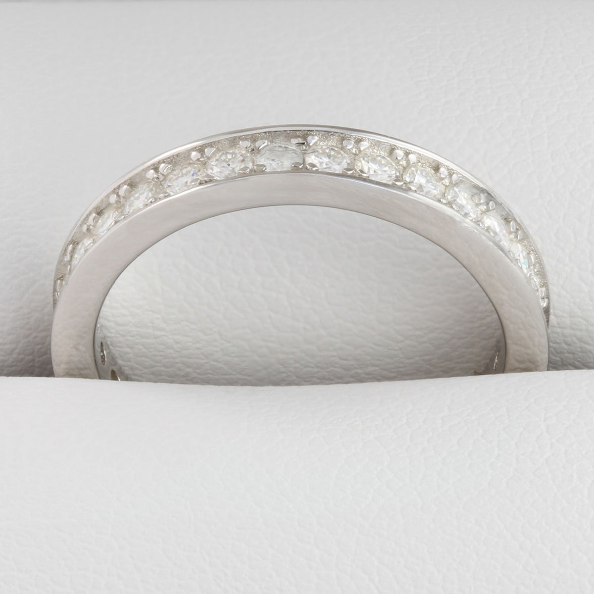 Close-up of round moissanite stones in white gold full eternity ring