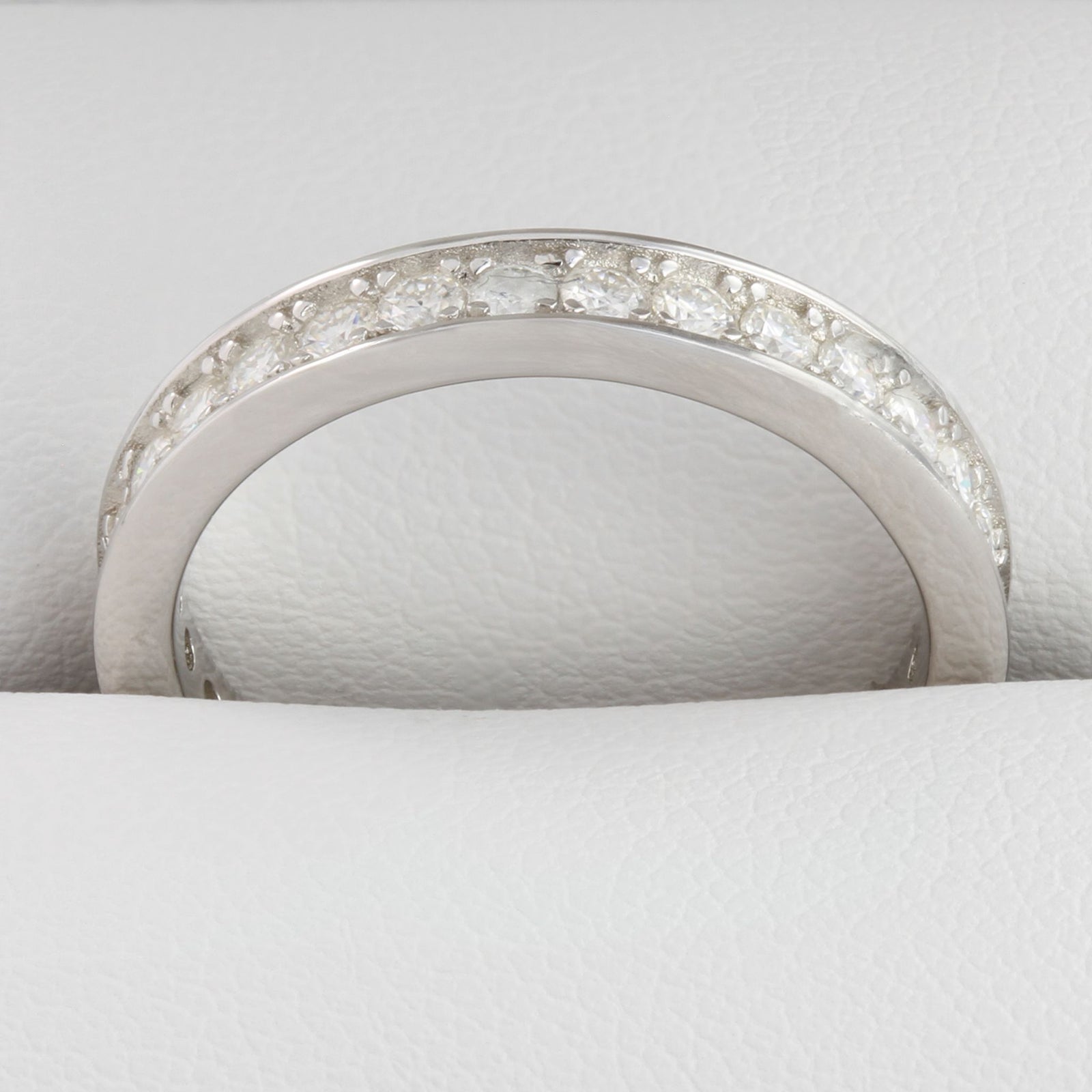 Close-up of round moissanite stones in white gold full eternity ring