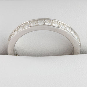 Close-up of round moissanite stones in white gold full eternity ring