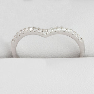 Close-up of round moissanite stones in white gold wishbone ring