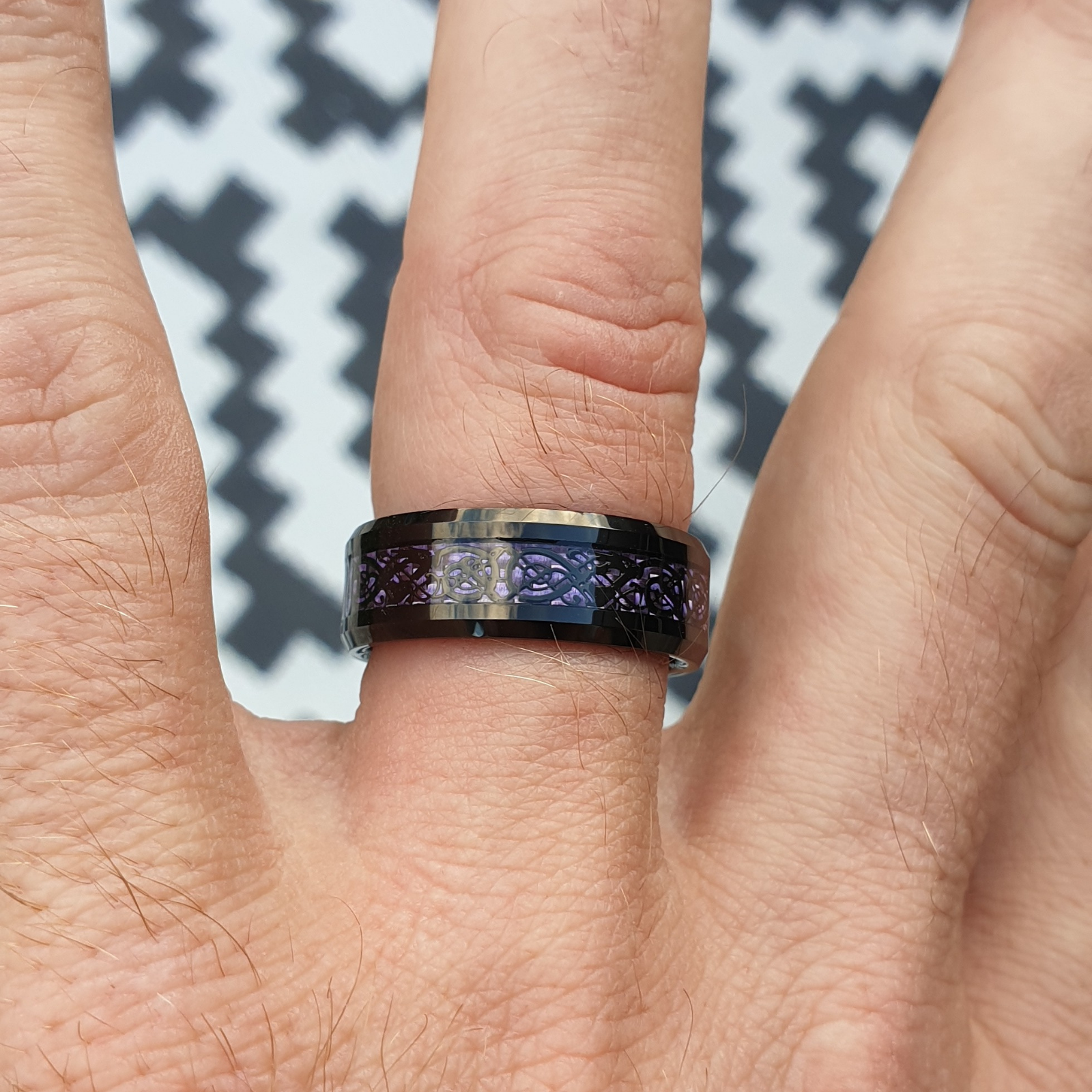 Close up of a hand wearing the purple Chinese dragon tungsten wonder ring